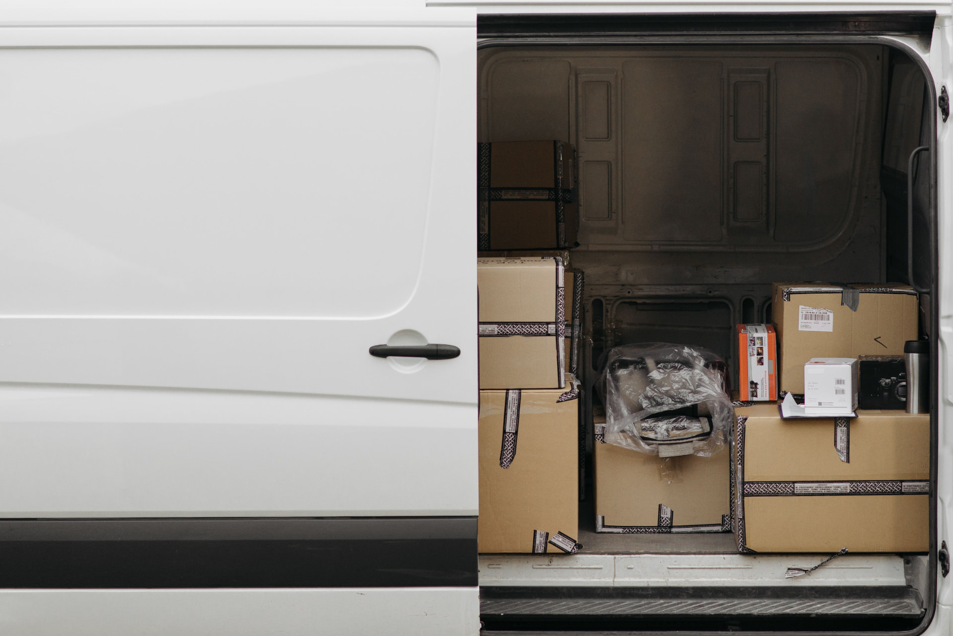 Cardboard freight boxes stacked inside a cargo van