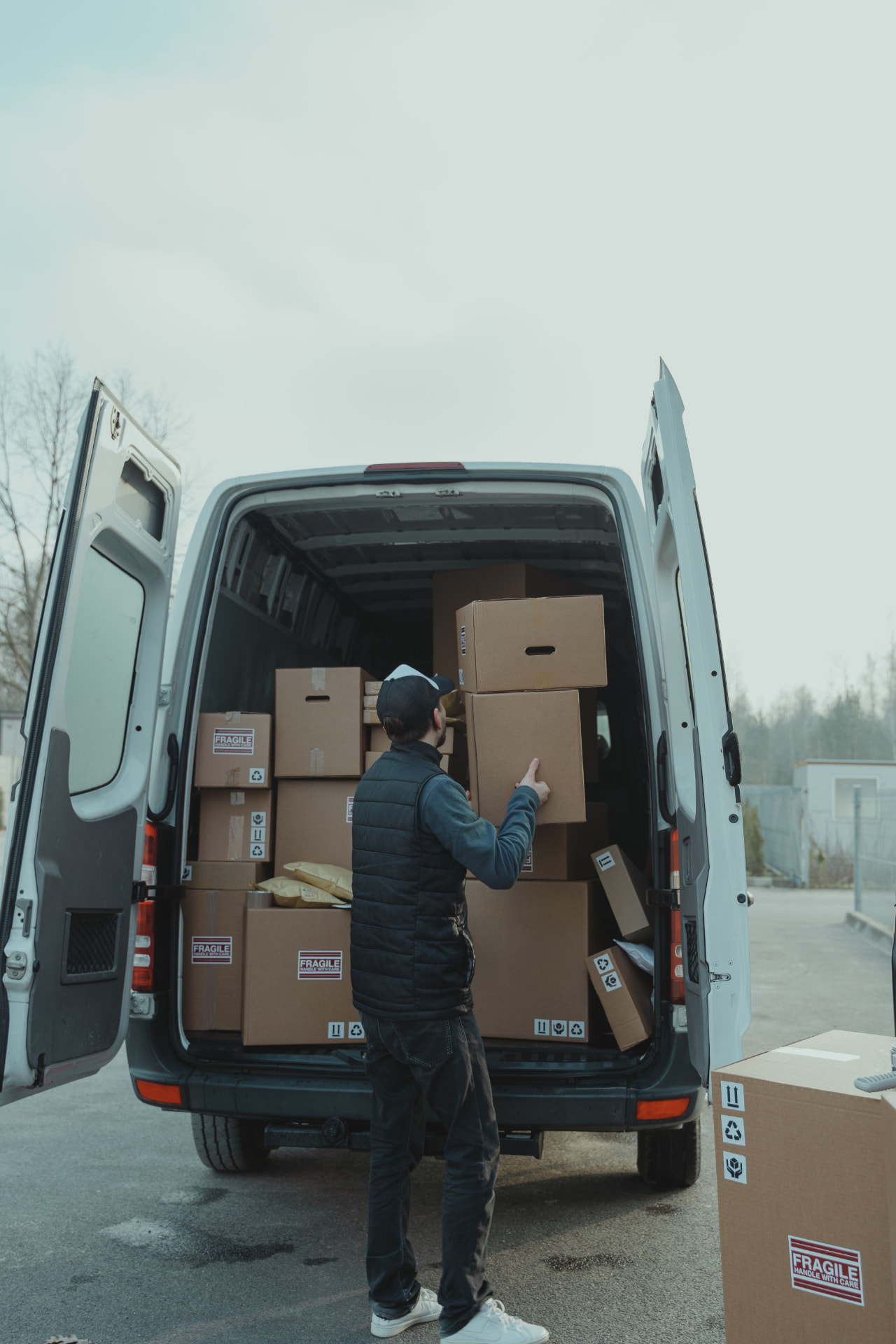 Boxed freight loaded into a cargo van at a warehouse dock